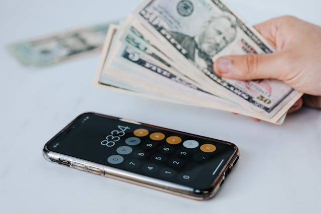 cash and calculator app on smartphone